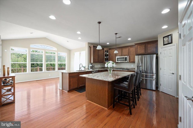 35 Gallery Rd, Stafford, VA 22554 - kitchen featuring appliances with stainless steel finishes, a peninsula, a center island, wood finished floors, and lofted ceiling