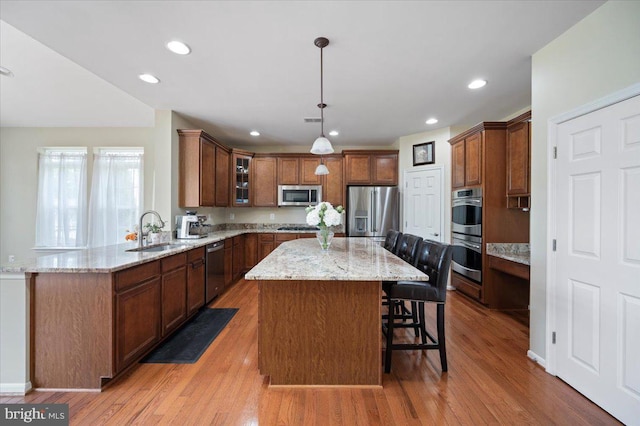 35 Gallery Rd, Stafford, VA 22554 - kitchen with appliances with stainless steel finishes, a center island, light wood-style flooring, and recessed lighting