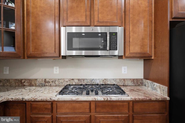 35 Gallery Rd, Stafford, VA 22554 - kitchen with appliances with stainless steel finishes, glass insert cabinets, and light stone counters