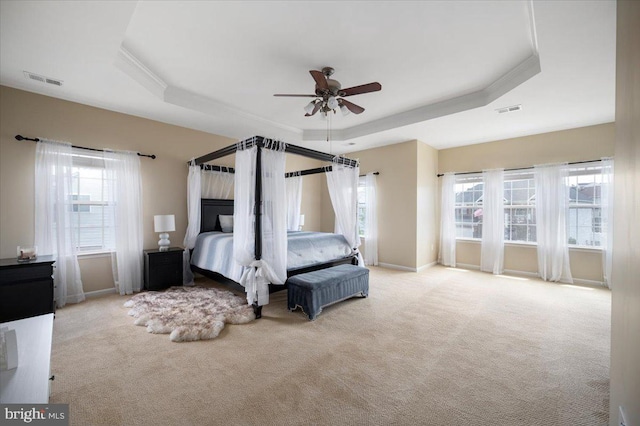 35 Gallery Rd, Stafford, VA 22554 - carpeted bedroom featuring a tray ceiling, multiple windows, crown molding, and ceiling fan