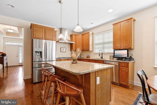 13 Doddington Blvd, Medford, NJ 08055 - kitchen with appliances with stainless steel finishes, wall chimney exhaust hood, a kitchen island, wood-type flooring, and plenty of natural light