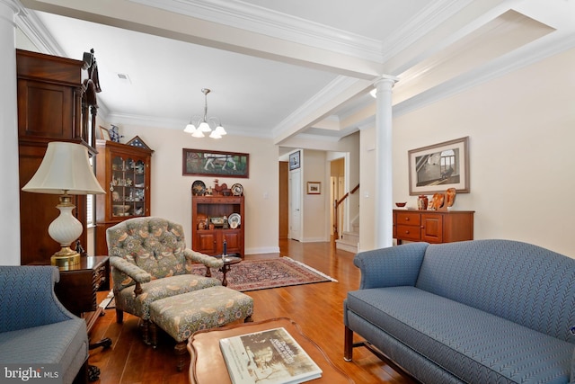 13 Doddington Blvd, Medford, NJ 08055 - living room featuring light wood-style flooring, stairs, a chandelier, ornamental molding, and ornate columns