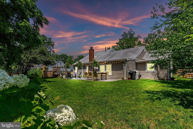 1739 Mayfair Pl, Crofton, MD 21114 - back of house at dusk with a patio and a chimney