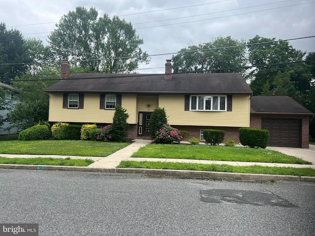 300 W New St, Glassboro, NJ 08028 - raised ranch with a chimney, a front lawn, a garage, and brick siding