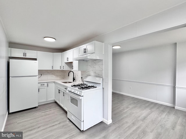 1504 Bonwood Rd, Wilmington, DE 19805 - kitchen with white appliances, under cabinet range hood, light countertops, light wood finished floors, and white cabinetry