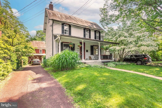 114 E Ashland St, Doylestown, PA 18901 - view of front of home with covered porch, a front yard, a chimney, and driveway