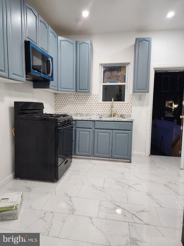 25 N 28th St, Camden, NJ 08105 - kitchen with black gas stove, stainless steel microwave, decorative backsplash, recessed lighting, and light marble finish flooring