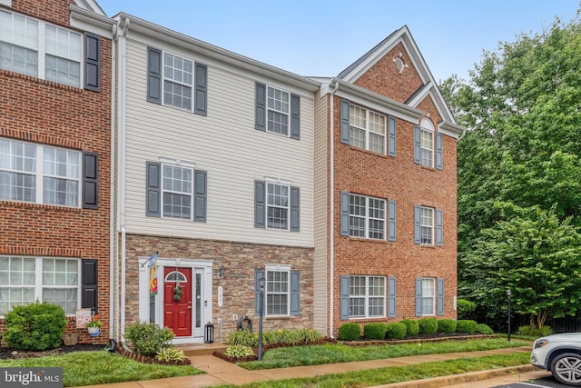 107 Pelican Cv, Stafford, VA 22554 - townhome / multi-family property with stone siding and uncovered parking