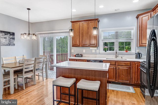 107 Pelican Cv, Stafford, VA 22554 - kitchen with healthy amount of natural light, brown cabinetry, light wood finished floors, light countertops, and recessed lighting