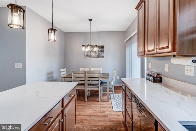 107 Pelican Cv, Stafford, VA 22554 - kitchen with light wood finished floors, a chandelier, hanging light fixtures, light stone countertops, and brown cabinets
