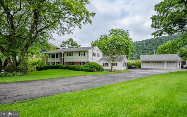 1 Emerald St, Mill Hall, PA 17751 - raised ranch featuring a detached garage, an outdoor structure, and a front yard