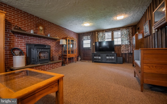 1 Emerald St, Mill Hall, PA 17751 - carpeted living room with a wood stove, a textured ceiling, brick wall, and wood walls