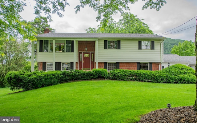 1 Emerald St, Mill Hall, PA 17751 - bi-level home with brick siding, a chimney, and a front lawn