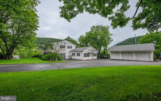 1 Emerald St, Mill Hall, PA 17751 - view of front of home featuring a front yard, an outdoor structure, and a detached garage