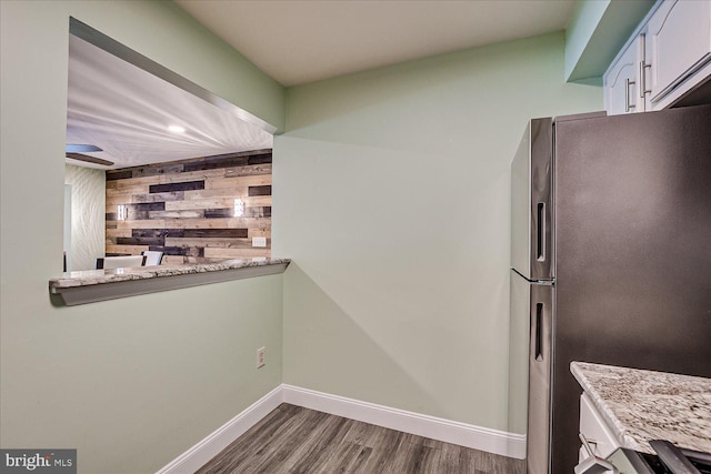 108 Wrangel Ct Unit 1, Princeton, NJ 08540 - kitchen with freestanding refrigerator, dark wood-style flooring, wood walls, and white cabinets
