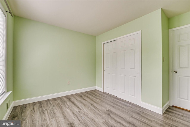 108 Wrangel Ct Unit 1, Princeton, NJ 08540 - unfurnished bedroom with light wood finished floors, a closet, and multiple windows