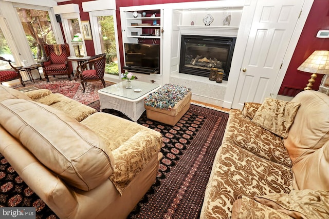 1722 Swamp Pike, Gilbertsville, PA 19525 - living room featuring a glass covered fireplace and built in shelves