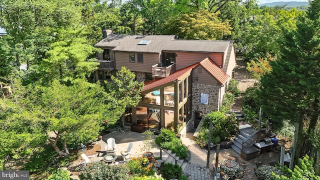 1722 Swamp Pike, Gilbertsville, PA 19525 - rear view of house with a balcony, stairs, a patio, stone siding, and a chimney