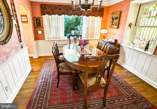 1722 Swamp Pike, Gilbertsville, PA 19525 - dining area featuring wood finished floors, a wainscoted wall, a chandelier, a decorative wall, and crown molding
