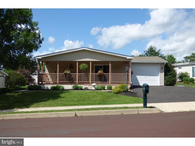 277 W 4th St, Red Hill, PA 18076 - single story home with a garage, covered porch, driveway, and a front yard
