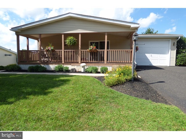 277 W 4th St, Red Hill, PA 18076 - view of front facade featuring a porch, an attached garage, a front lawn, and driveway