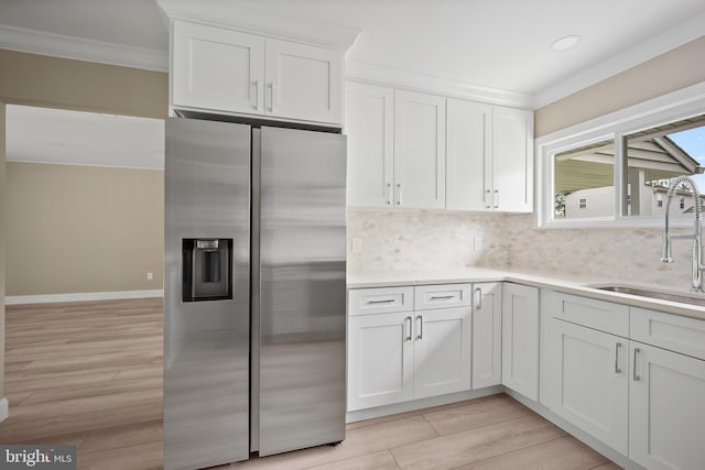 116 Hollow Rd, Levittown, PA 19056 - kitchen with stainless steel refrigerator with ice dispenser, crown molding, light wood-style floors, decorative backsplash, and white cabinetry