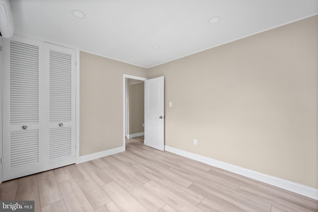 116 Hollow Rd, Levittown, PA 19056 - unfurnished bedroom featuring light wood-style flooring, a closet, and an AC wall unit