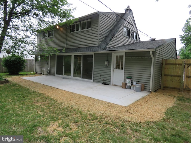 116 Hollow Rd, Levittown, PA 19056 - rear view of house featuring roof with shingles, a patio area, and a chimney