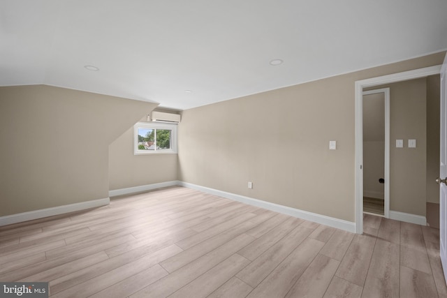 116 Hollow Rd, Levittown, PA 19056 - spare room featuring light wood-style flooring, an AC wall unit, and lofted ceiling