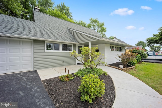 116 Hollow Rd, Levittown, PA 19056 - view of front of house featuring a shingled roof, a chimney, asphalt driveway, and an attached garage