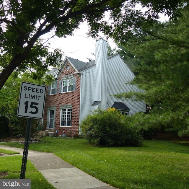 732 Balls Bluff Rd NE, Leesburg, VA 20176 - view of front facade with brick siding, a chimney, and a front yard