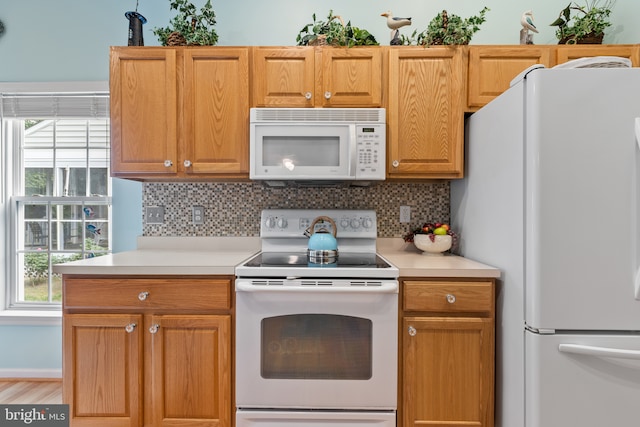 32618 Seaview Loop, Millsboro, DE 19966 - kitchen with white appliances, decorative backsplash, light countertops, and healthy amount of natural light