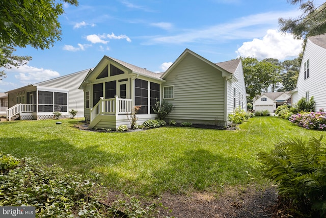32618 Seaview Loop, Millsboro, DE 19966 - rear view of house featuring a sunroom, a lawn, and roof with shingles