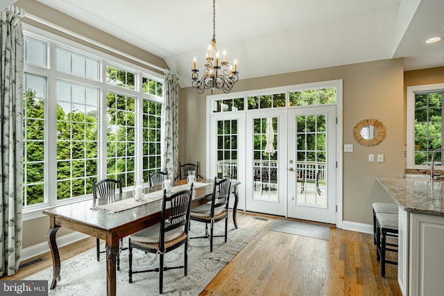 4 Taylor Chase Ln, West Chester, PA 19382 - dining area featuring french doors, a chandelier, lofted ceiling, and light wood-type flooring