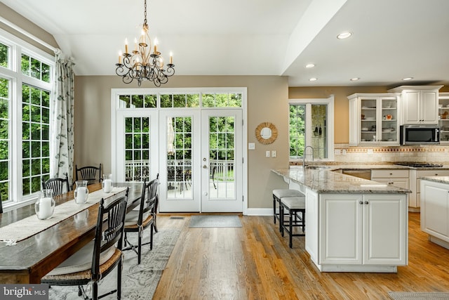 4 Taylor Chase Ln, West Chester, PA 19382 - kitchen with stainless steel appliances, french doors, a breakfast bar area, tasteful backsplash, and glass insert cabinets