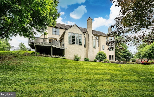 4 Taylor Chase Ln, West Chester, PA 19382 - rear view of property with stucco siding, a deck, a chimney, and a lawn
