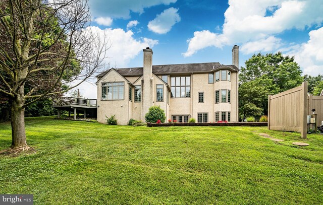 4 Taylor Chase Ln, West Chester, PA 19382 - rear view of property with a chimney, a yard, stucco siding, and a wooden deck