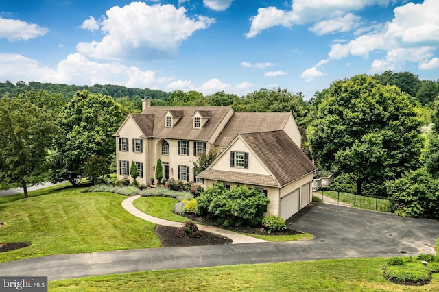 4 Taylor Chase Ln, West Chester, PA 19382 - view of front of home featuring driveway, a garage, a chimney, and stucco siding