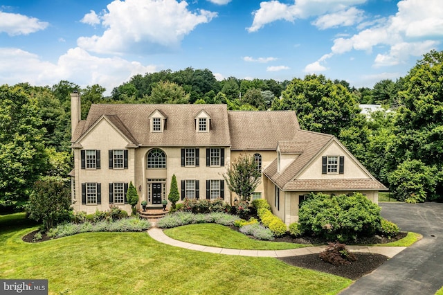 4 Taylor Chase Ln, West Chester, PA 19382 - colonial-style house featuring a chimney, a front lawn, and stucco siding
