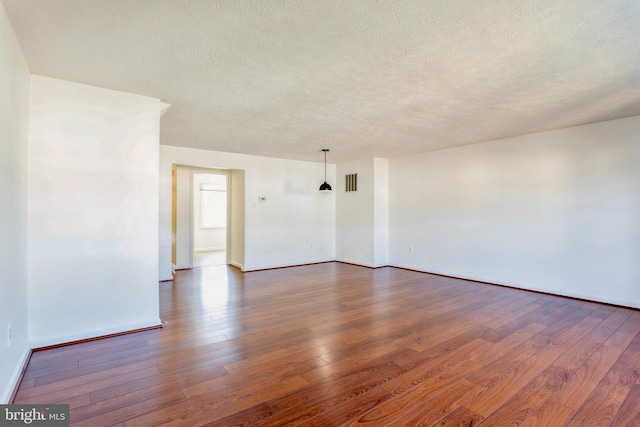 8 Tatler Pl, Owings Mills, MD 21117 - empty room featuring a textured ceiling and dark wood finished floors
