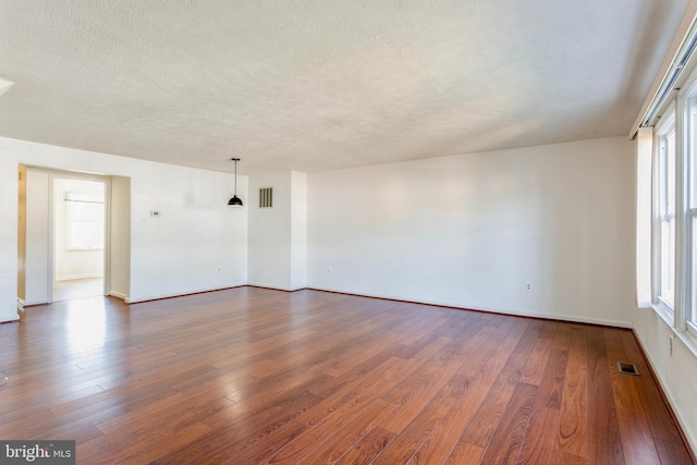 8 Tatler Pl, Owings Mills, MD 21117 - unfurnished room featuring a textured ceiling and dark wood-style flooring