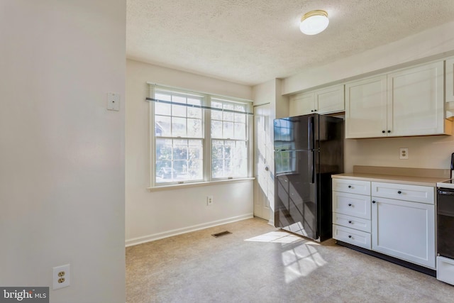 8 Tatler Pl, Owings Mills, MD 21117 - kitchen with freestanding refrigerator, a textured ceiling, light countertops, range, and white cabinetry