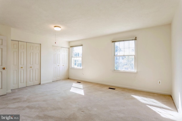 8 Tatler Pl, Owings Mills, MD 21117 - unfurnished bedroom with two closets and carpet