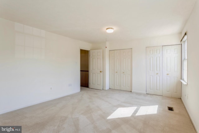 8 Tatler Pl, Owings Mills, MD 21117 - unfurnished bedroom featuring two closets and carpet