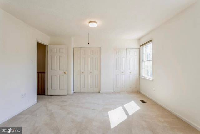 8 Tatler Pl, Owings Mills, MD 21117 - unfurnished bedroom with two closets and carpet flooring