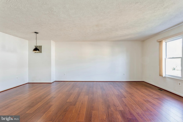 8 Tatler Pl, Owings Mills, MD 21117 - unfurnished room with dark wood-style flooring and a textured ceiling