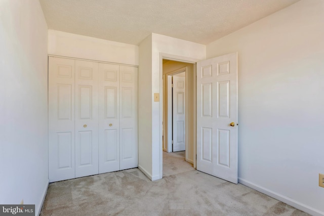 8 Tatler Pl, Owings Mills, MD 21117 - unfurnished bedroom with carpet, a closet, and a textured ceiling
