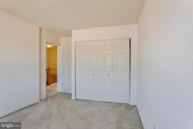 8 Tatler Pl, Owings Mills, MD 21117 - unfurnished bedroom with carpet floors, a closet, and a textured ceiling