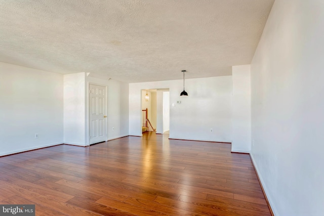 8 Tatler Pl, Owings Mills, MD 21117 - empty room featuring a textured ceiling and dark wood finished floors
