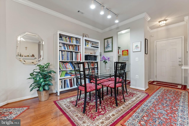 9480 Virginia Center Blvd Unit 327, Vienna, VA 22181 - dining space featuring wood finished floors, track lighting, and crown molding